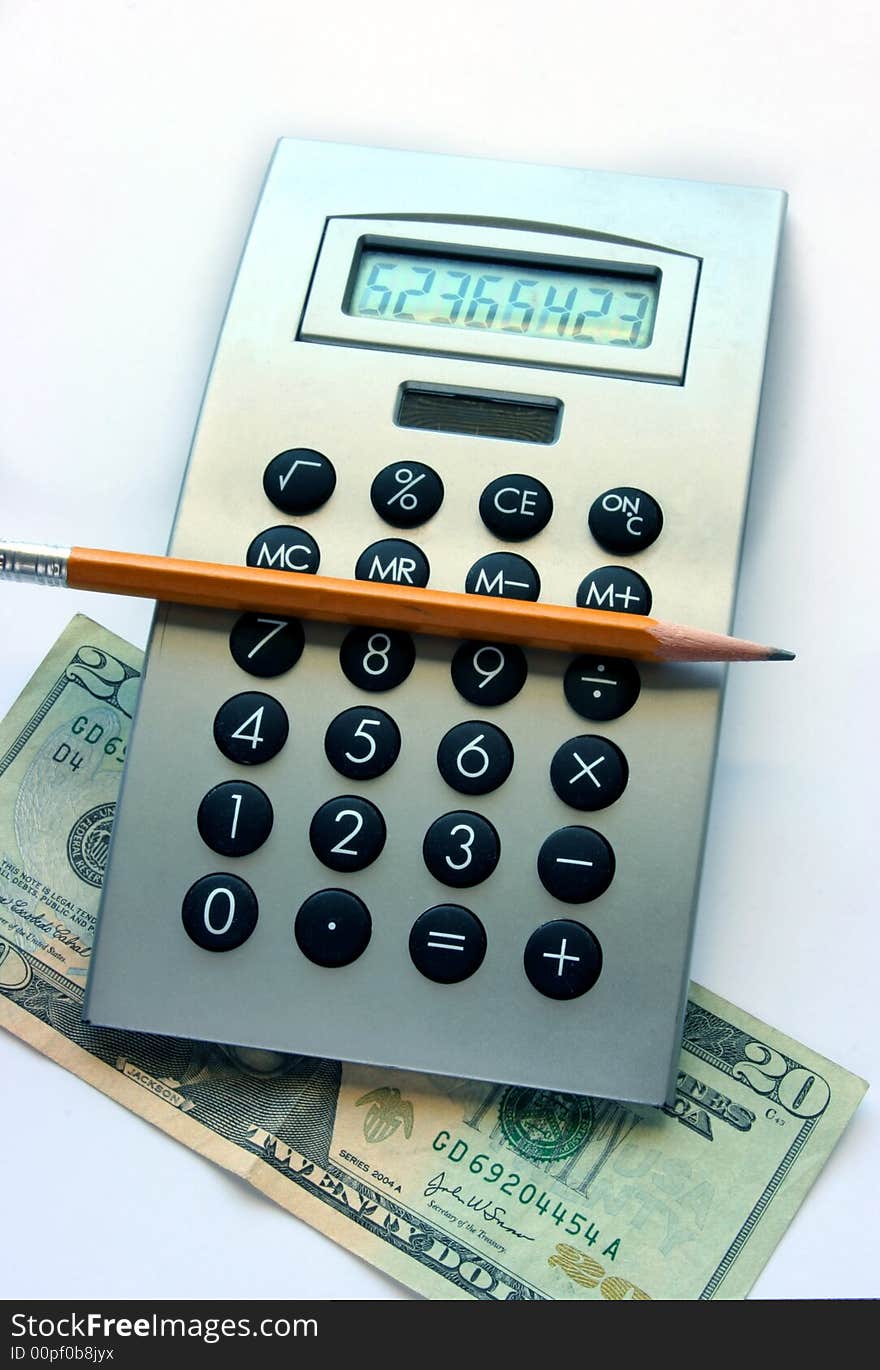 Calculator, pencil and twenty dollars bill on the table