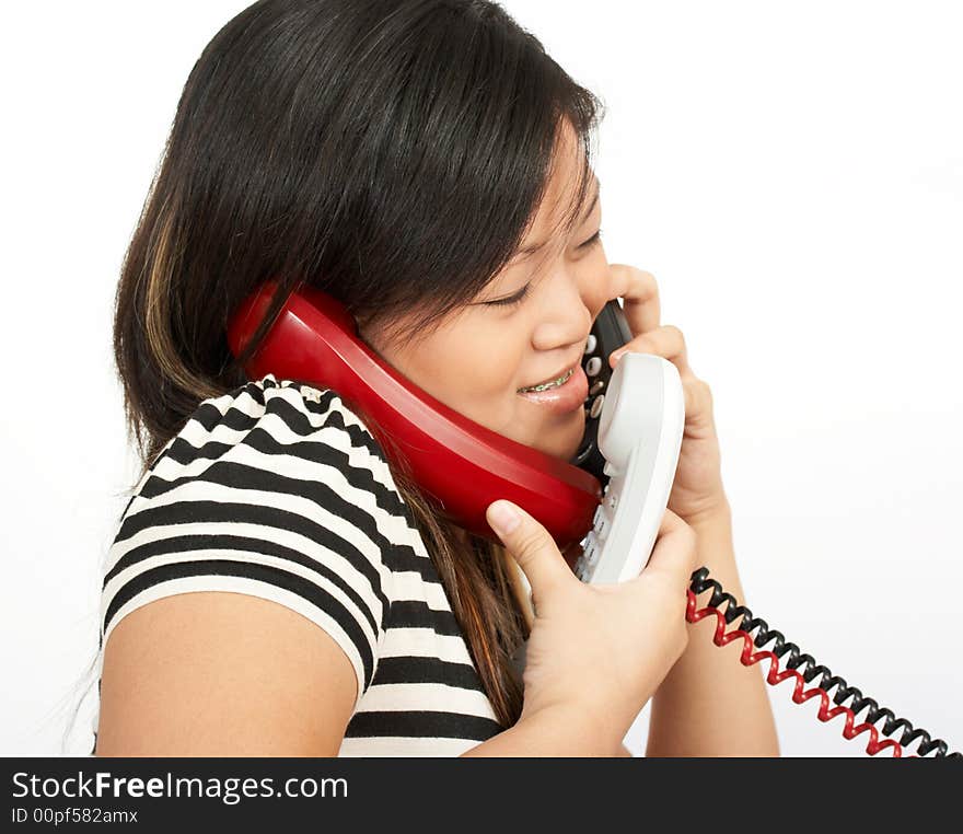 A woman answering multiple phones over a white background. A woman answering multiple phones over a white background