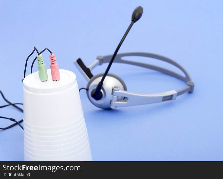 A computer headset over a blue background