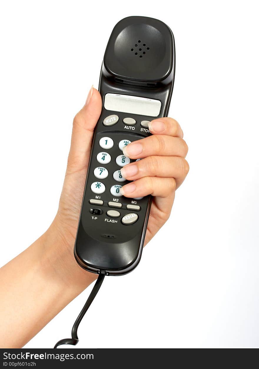 A hand holding a  telephone handset over a white background. A hand holding a  telephone handset over a white background