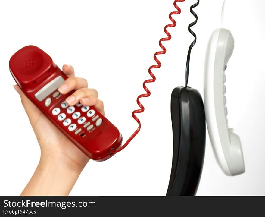 Handset phones hanging over a white background. Handset phones hanging over a white background