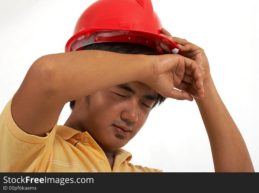 A man wearing a hard hat over a white background. A man wearing a hard hat over a white background