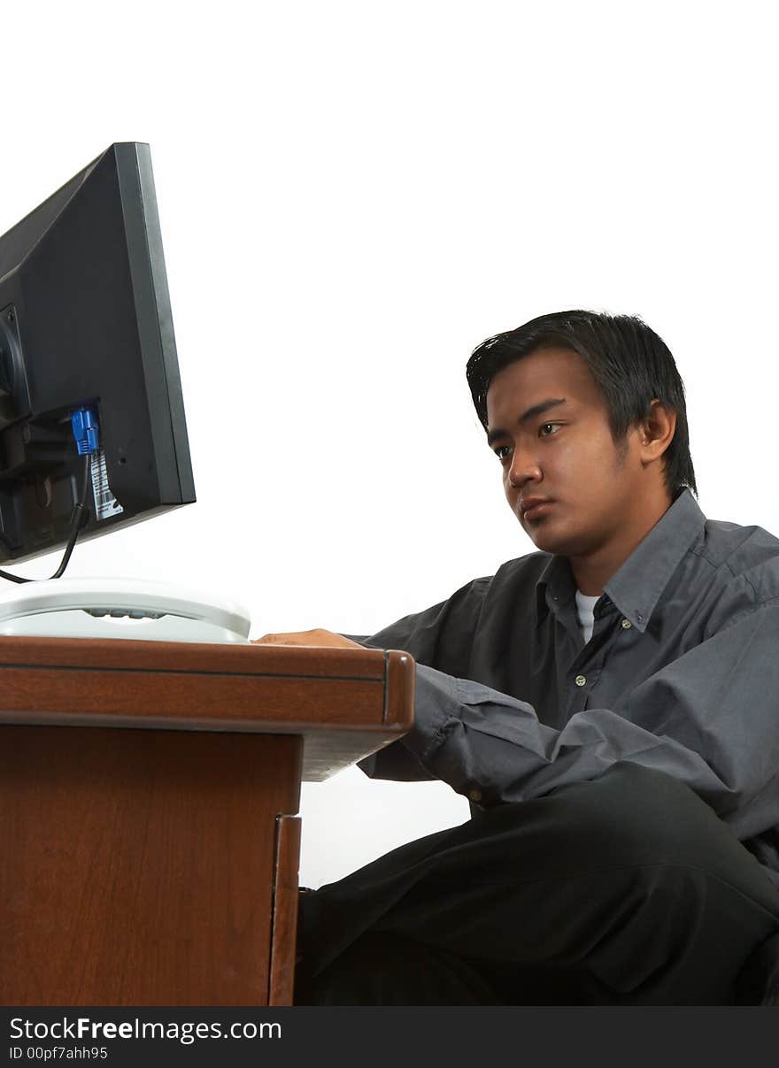 A man working on his desktop computer. A man working on his desktop computer