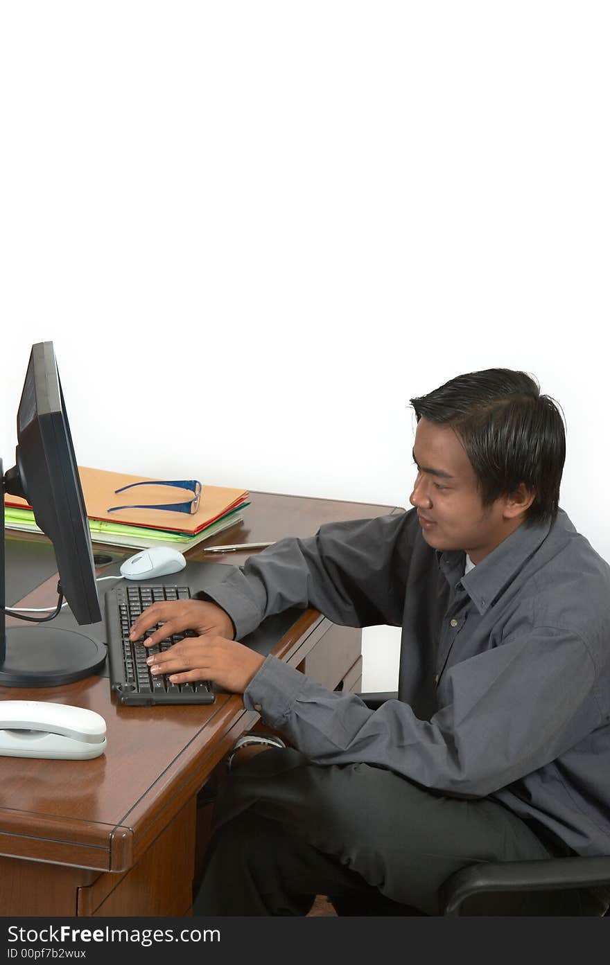 A man working on his desktop computer. A man working on his desktop computer