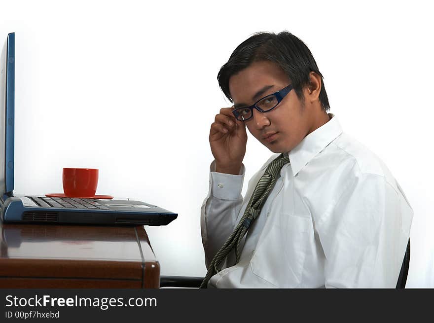 A man working on his laptop over a white background. A man working on his laptop over a white background