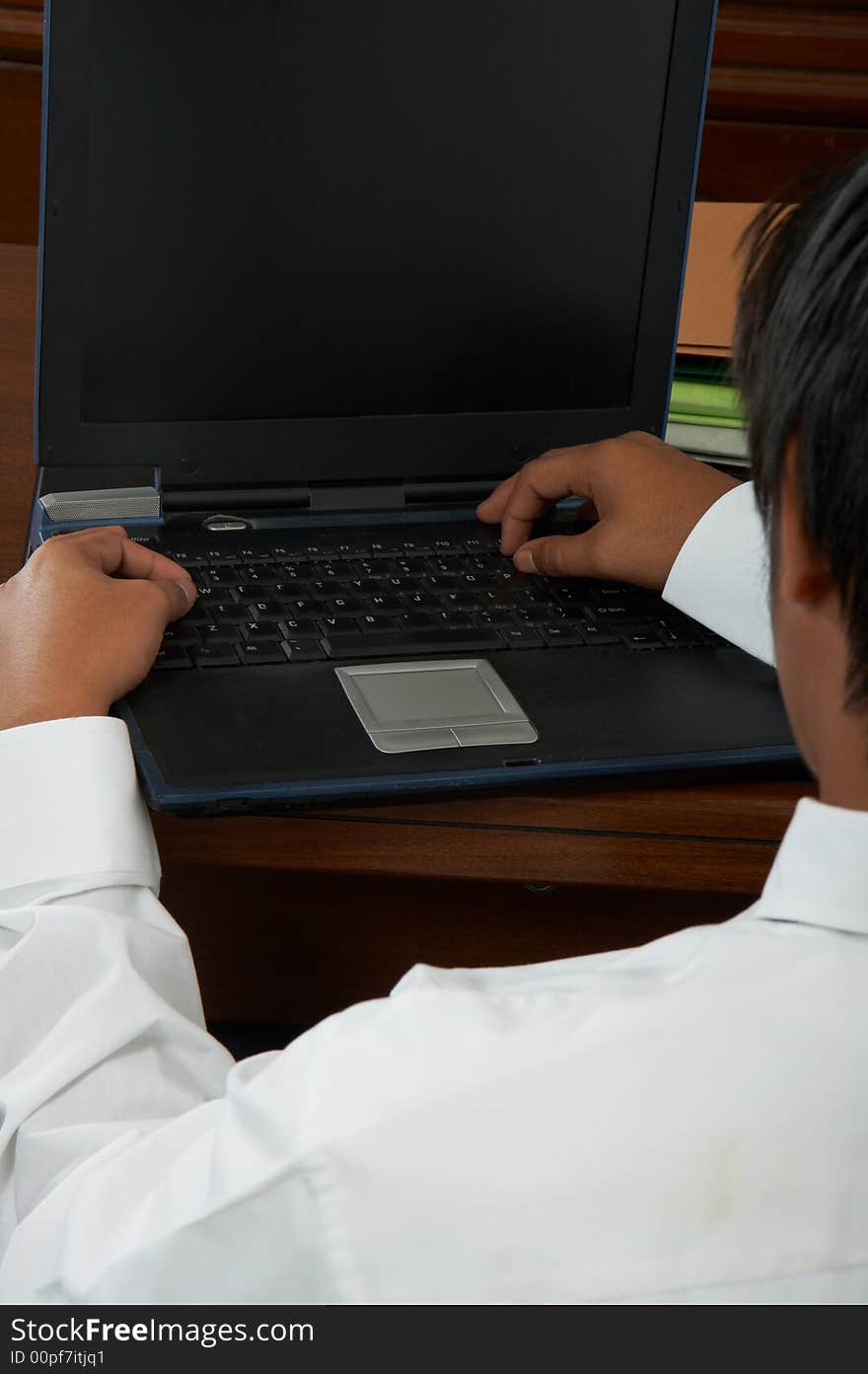 A close-up shot of a man working on his laptop. A close-up shot of a man working on his laptop