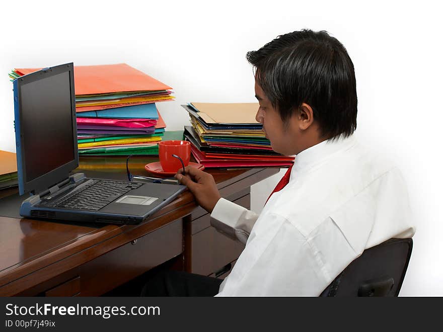 A man working on his laptop over a white background. A man working on his laptop over a white background