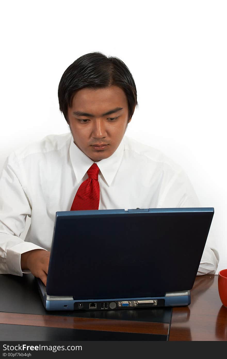 A man working on his laptop over a white background. A man working on his laptop over a white background