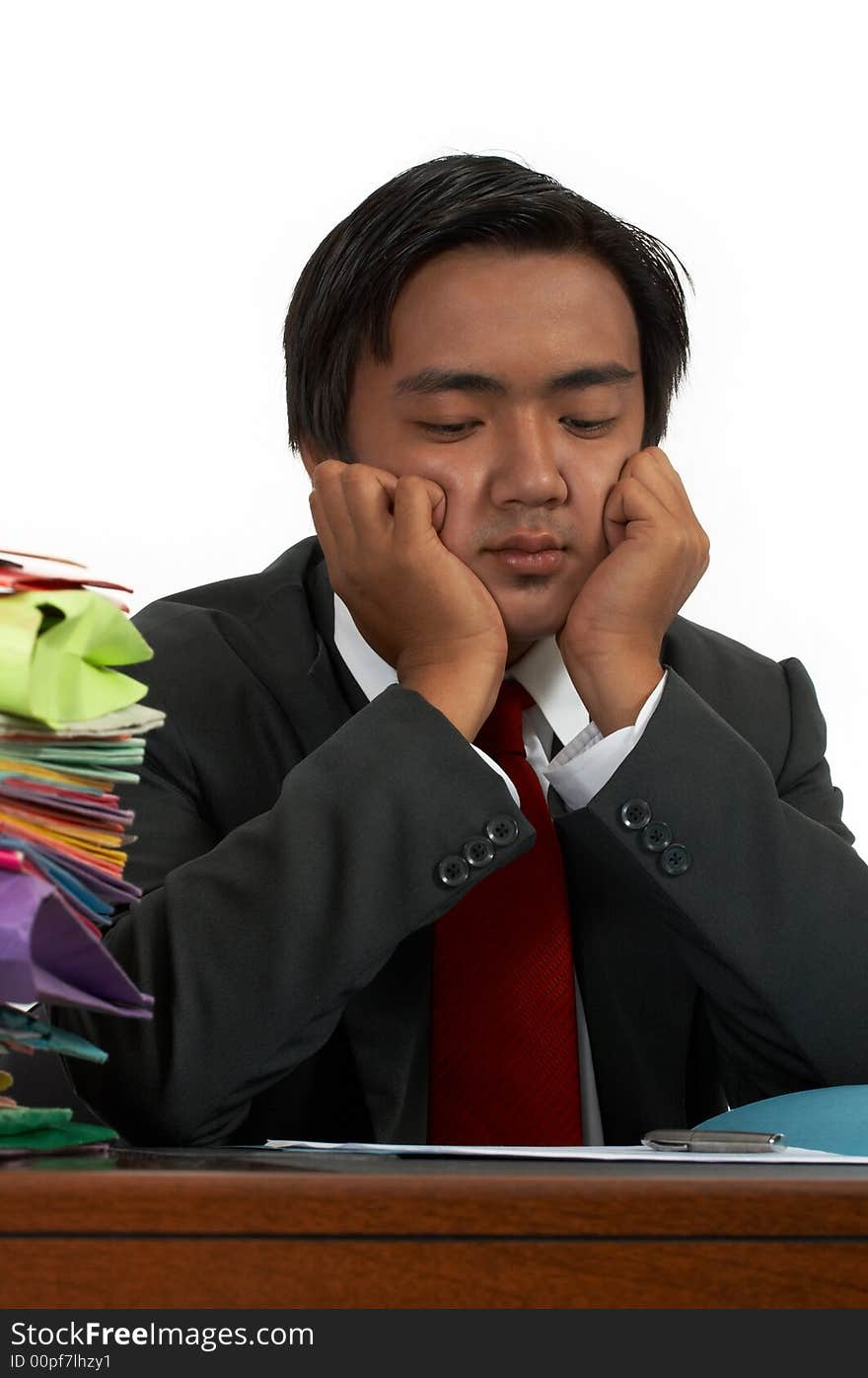 A man sitting behind his office desk. A man sitting behind his office desk