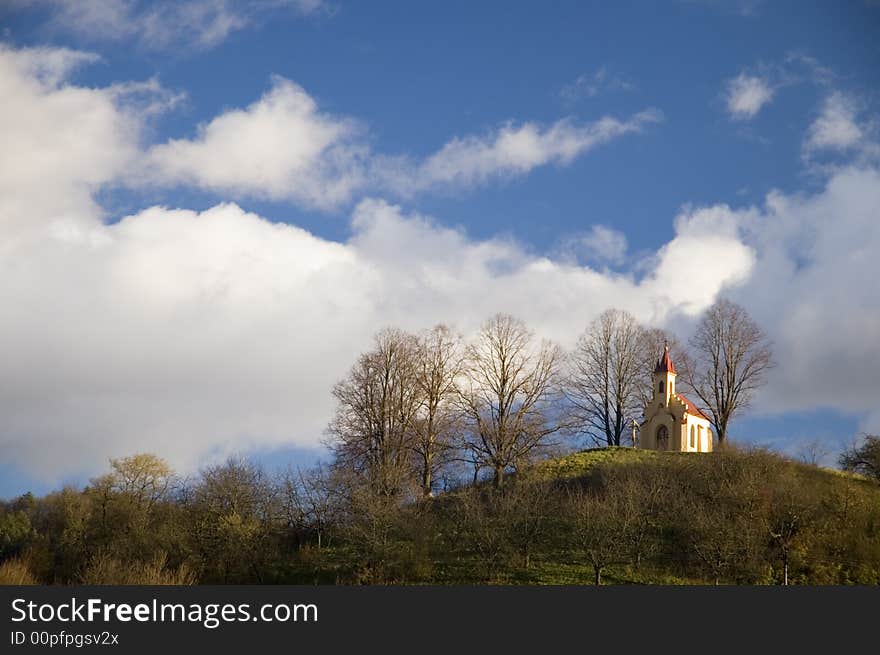 Historical roman-catholic church at the top of the hill with the trees on the sides. Historical roman-catholic church at the top of the hill with the trees on the sides