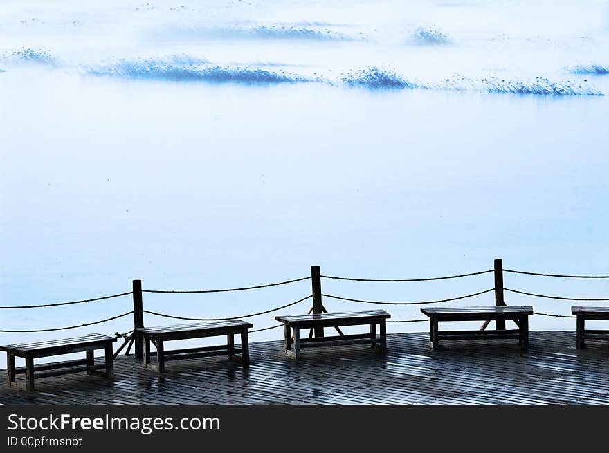Chairs on the misty lake shore. Chairs on the misty lake shore