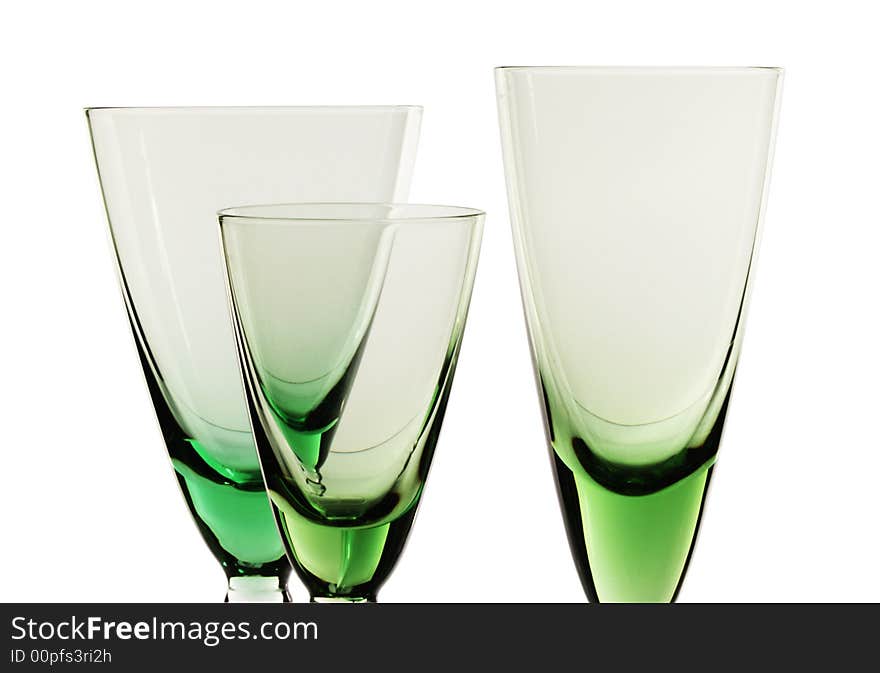 A glass beside a stack of white plates - on white background. A glass beside a stack of white plates - on white background