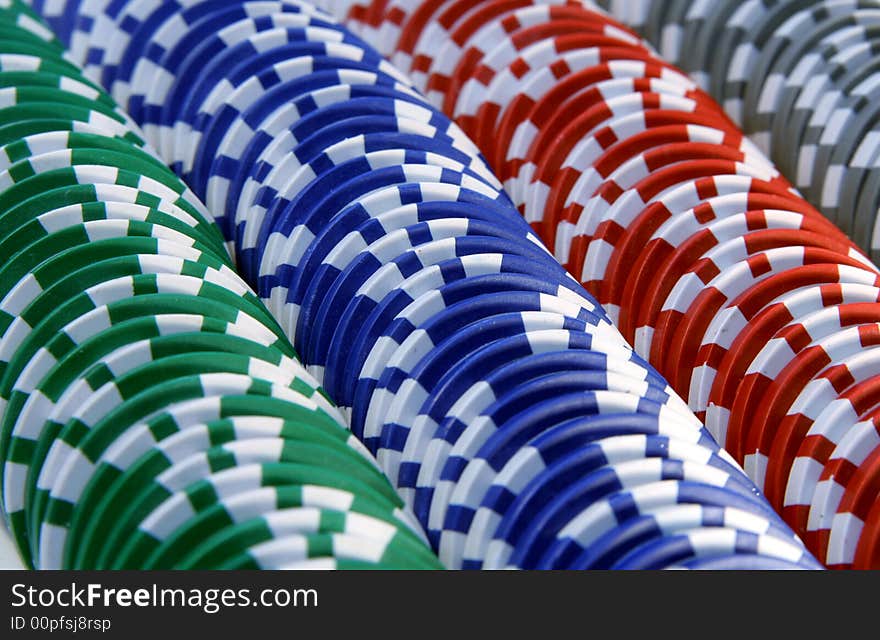 Abstract background with casino chips in five colors: red, blue, green, gray and white