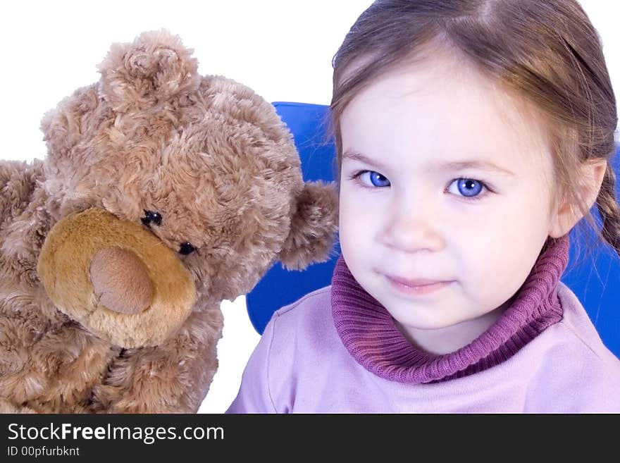 A sweet baby girl with her teddy bear and smiles