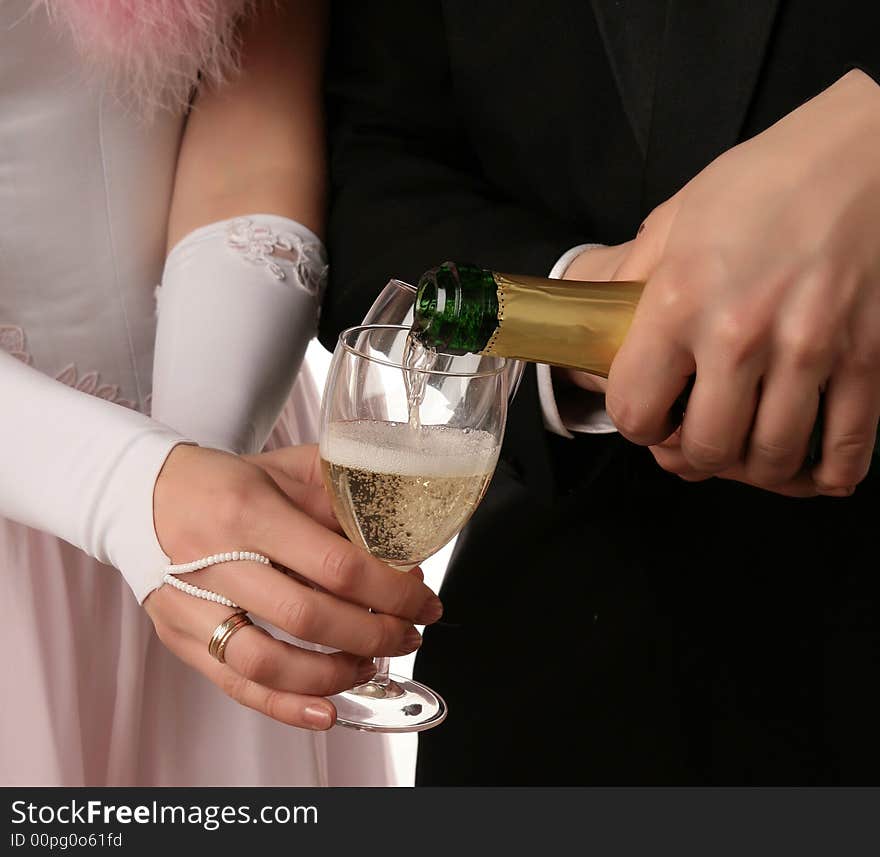 The two hands with a bootle of champagne