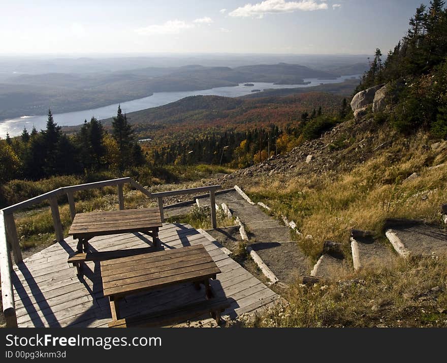 Hiking trail on the mountain, a picnic table with a colorful autumn scene. Hiking trail on the mountain, a picnic table with a colorful autumn scene