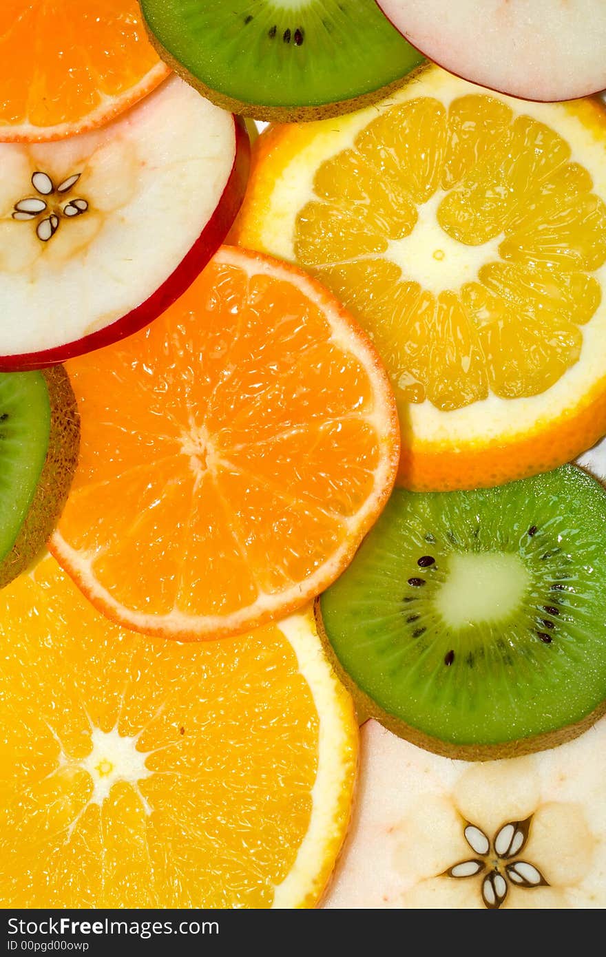 Fruits background from slices kiwi, apple, tangerine and orange. Fruits background from slices kiwi, apple, tangerine and orange