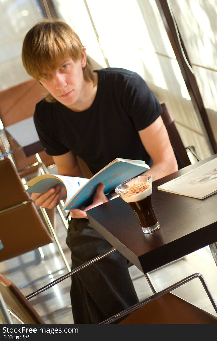 Cup of coffe and man on the background in shall DOF. Cup of coffe and man on the background in shall DOF