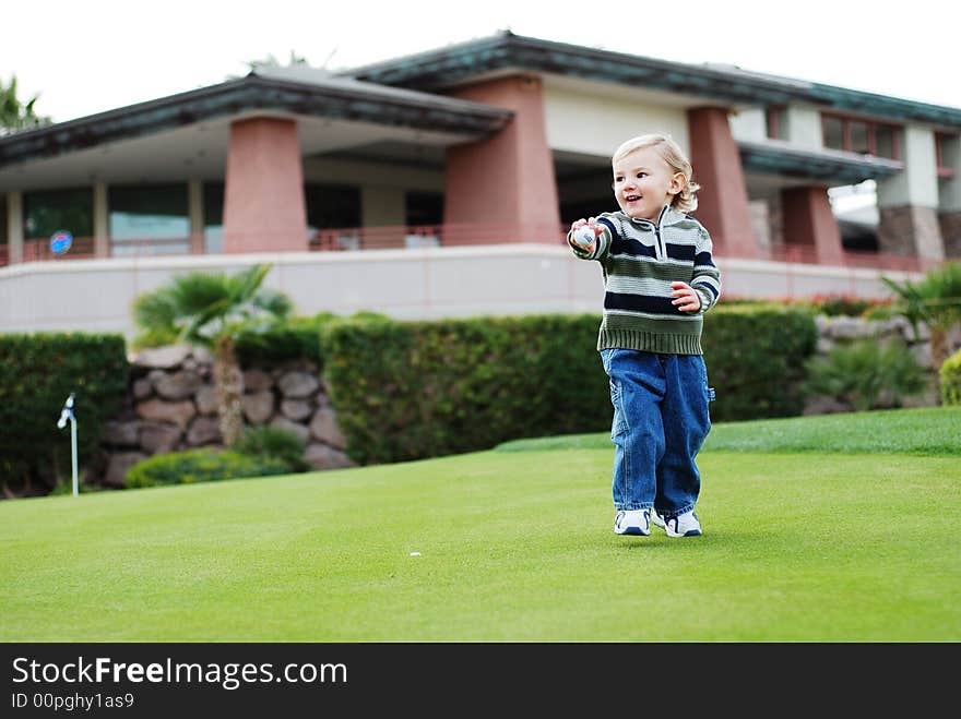 A little kid is enjoying his time in the park. A little kid is enjoying his time in the park