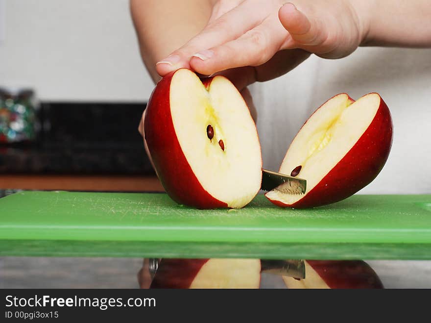 Apple on the counter symbolizes healthy living and nutritional value. Apple on the counter symbolizes healthy living and nutritional value