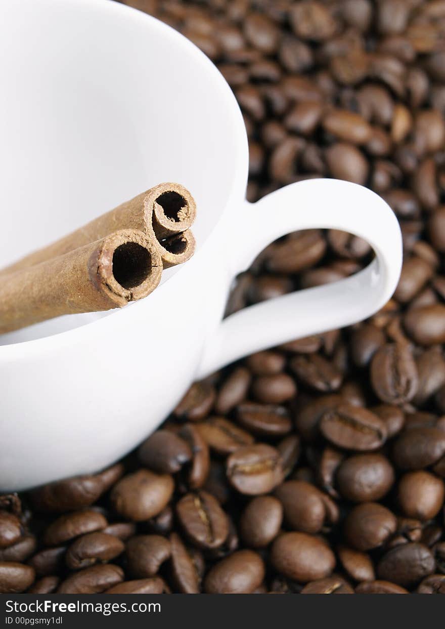 Cup. coffee beans and cinnamon