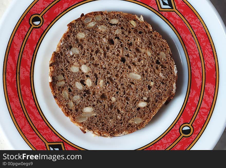 Rye bread with seeds on the plate. Rye bread with seeds on the plate.