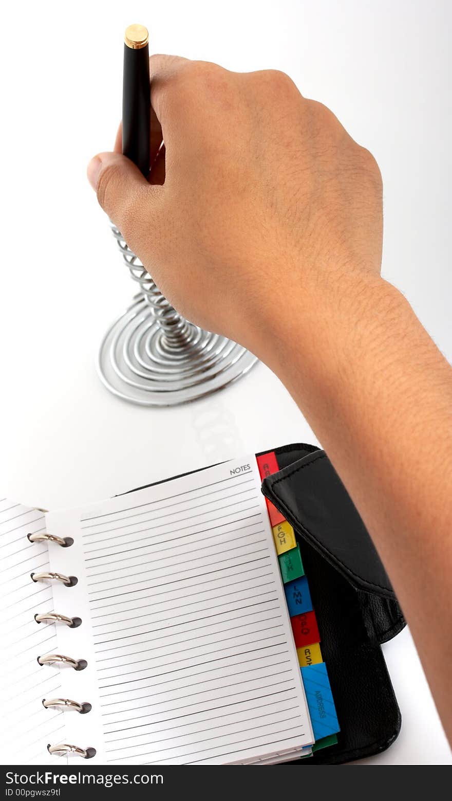 A pen and an organizer over a white background. A pen and an organizer over a white background