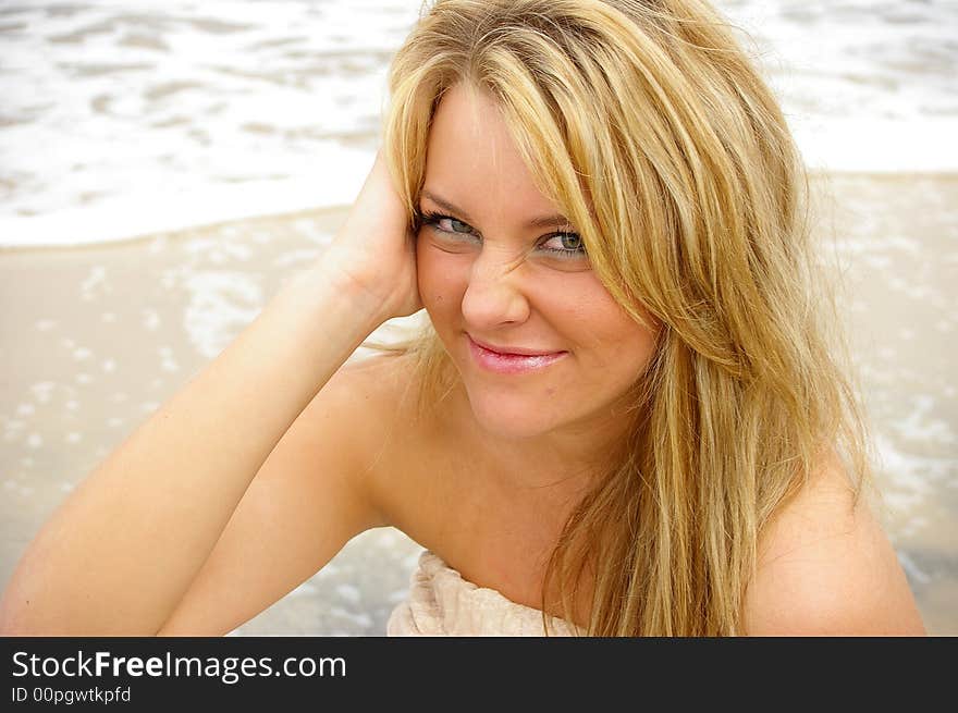 Beautiful girl on the beach grinning and having fun. Beautiful girl on the beach grinning and having fun