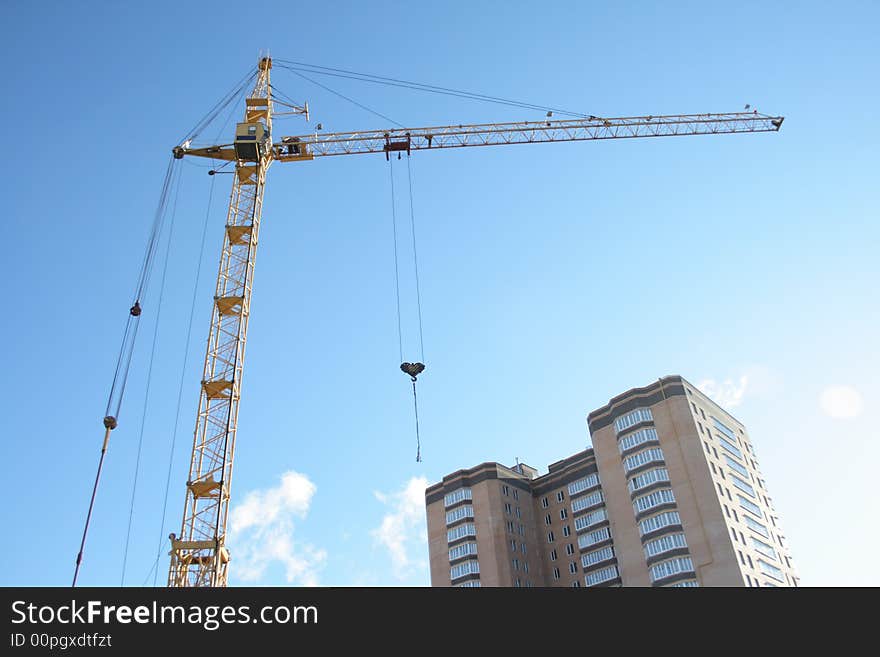 Building tower crane on blue sky