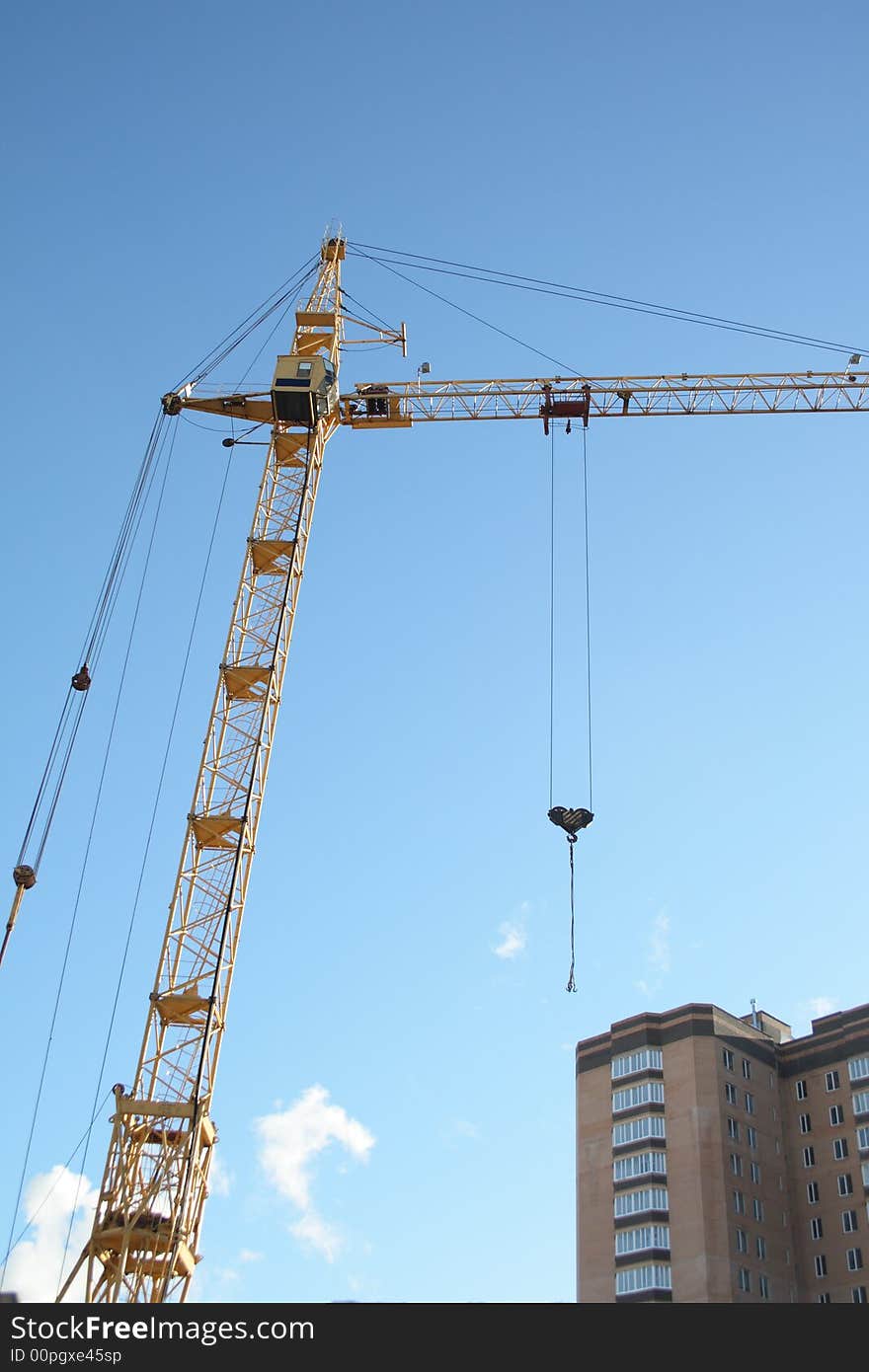 Building tower crane on blue sky