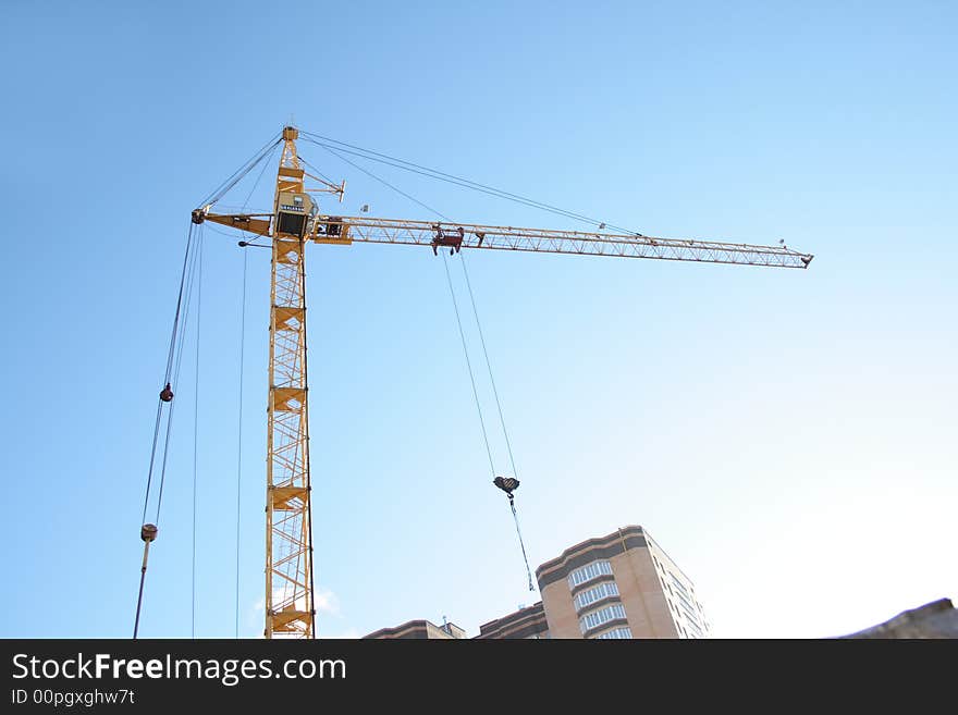 Building tower crane on blue sky