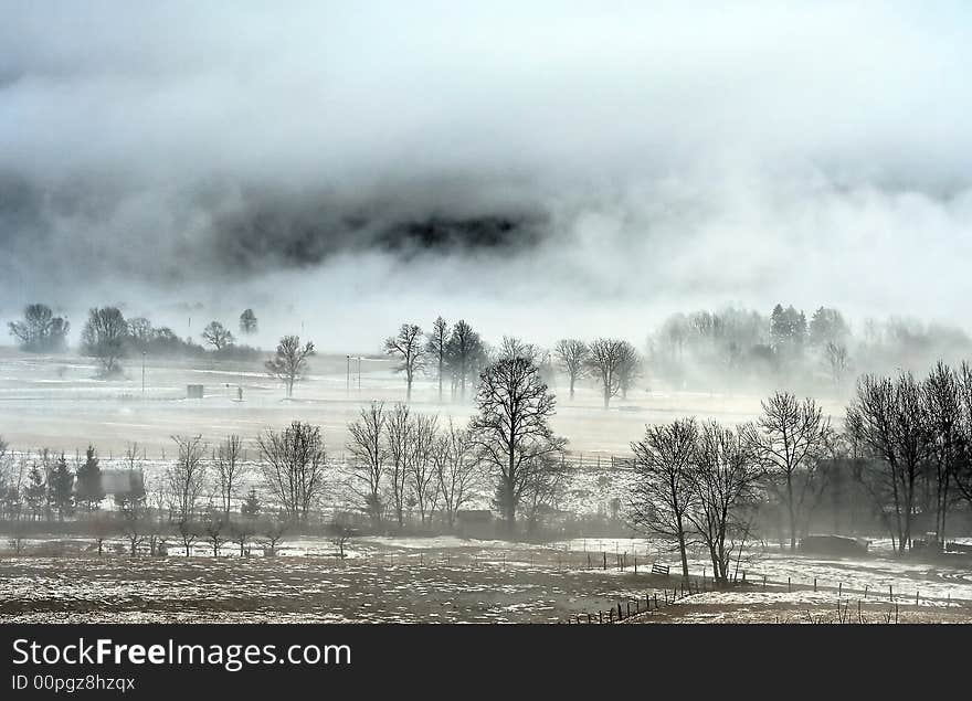 Alpine valley in fog and snow. Alpine valley in fog and snow