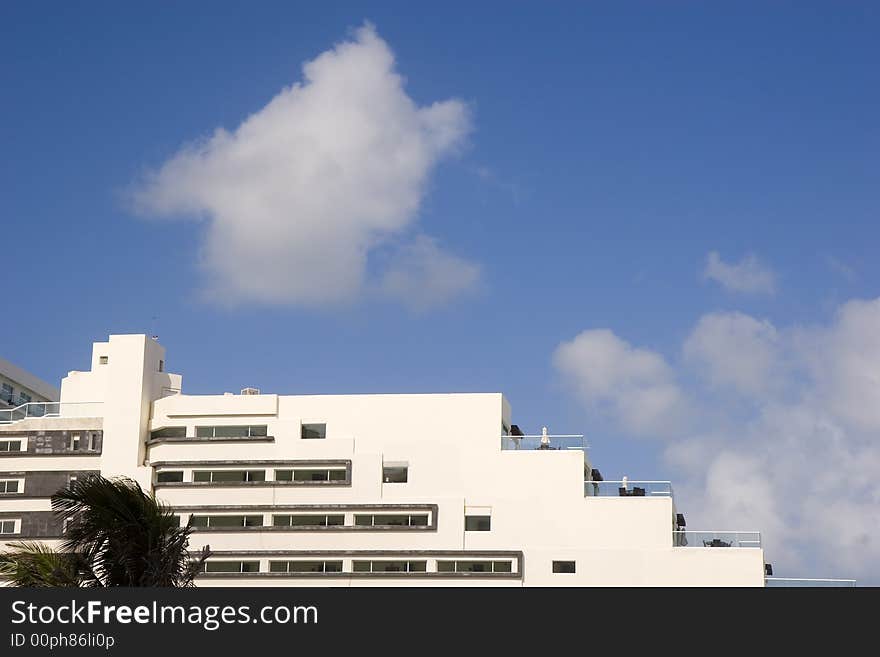 White Terraced Hotel And Clouds