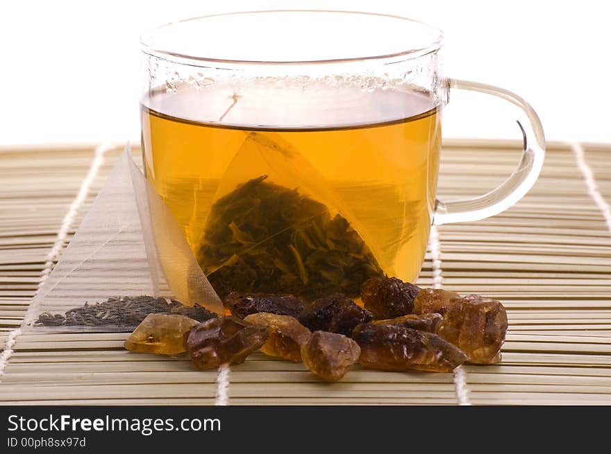 White tea, nylon tea-bag and golden sugar. White tea, nylon tea-bag and golden sugar