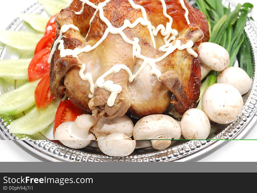 Grill chicken with vegetables on silver plate