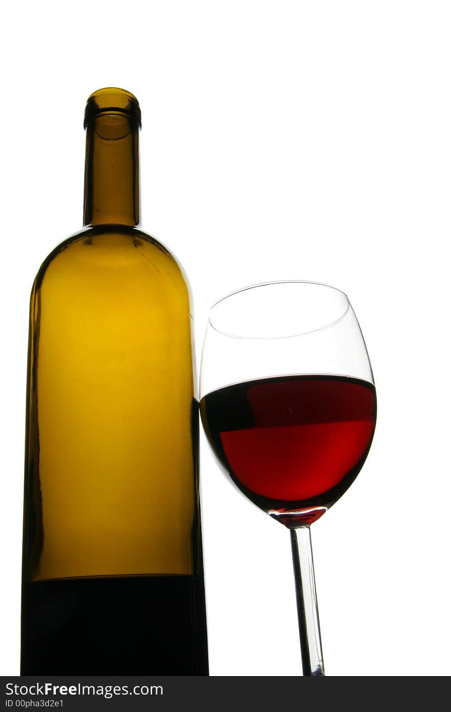 Glass and bottle of red wine isolated over white background