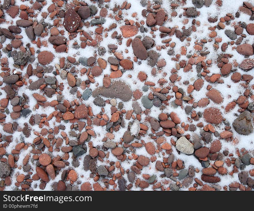 Cobbles in snow on the agate beach