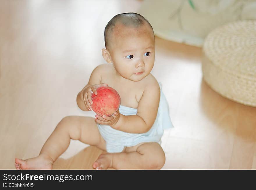 Little boy with a red peach in hand. Little boy with a red peach in hand