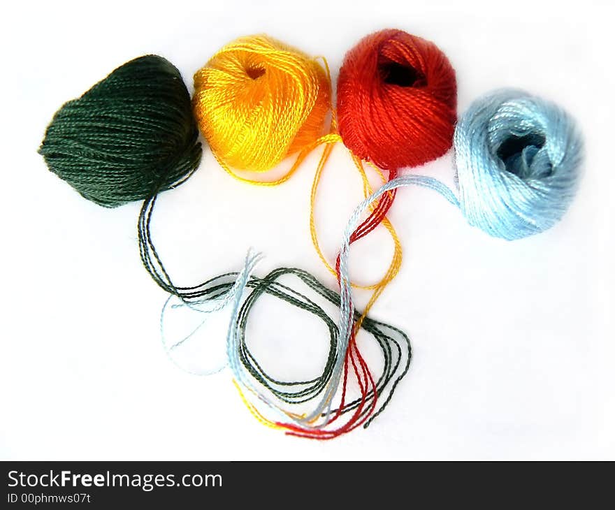 Colorful threads on white background