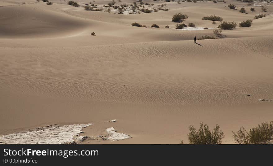 A solitary person in the dunes in Death Valley, CA. A solitary person in the dunes in Death Valley, CA