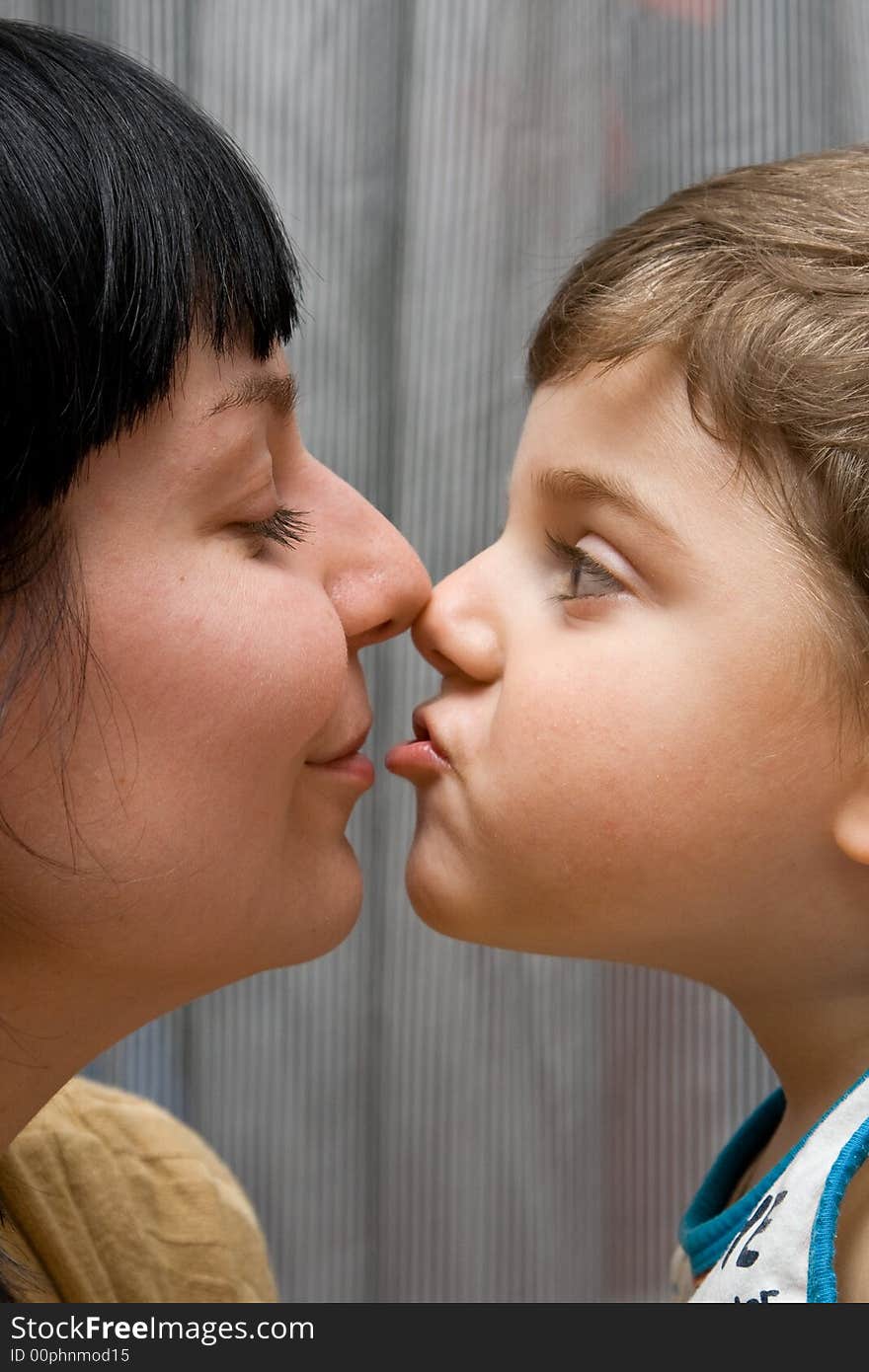 Mum and the son kiss.