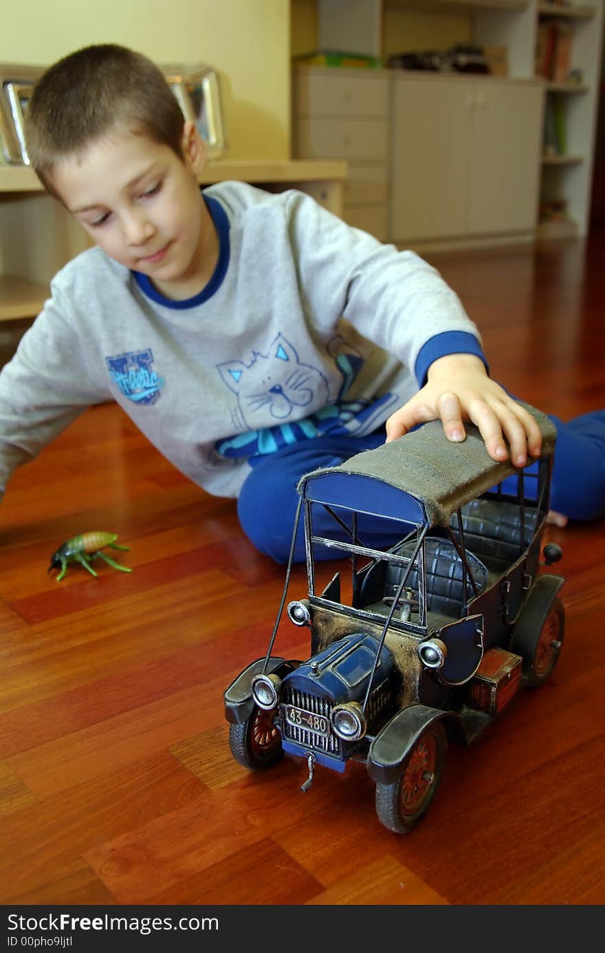 A Child Plays With The Cars