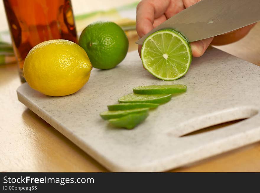 Slicing a lime on a cutting board.