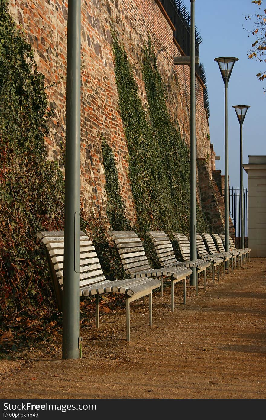 White seats and lamps in city park