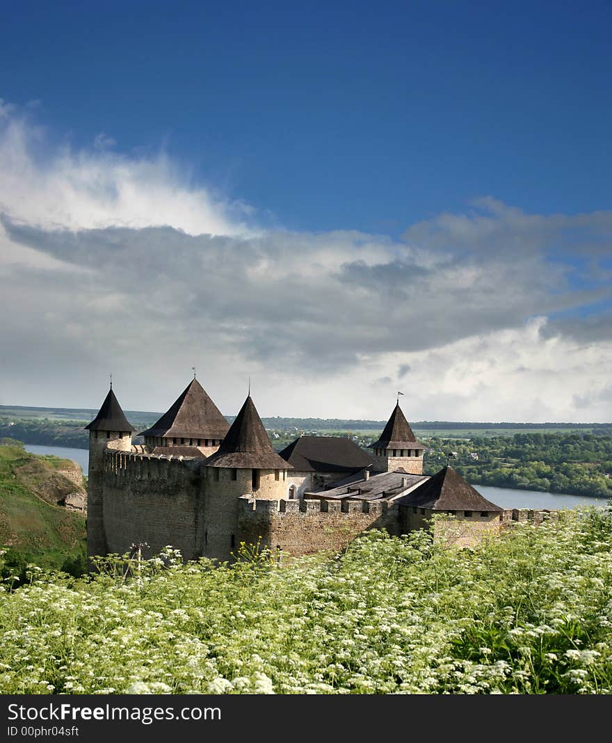 Old fortress with a green grass in the foreground