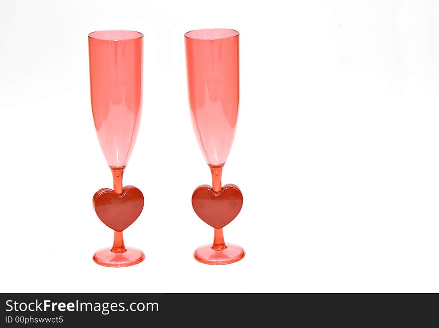 A pair of pink and red champagne glasses - valentines, weddings, engagement, celebrations of love. A pair of pink and red champagne glasses - valentines, weddings, engagement, celebrations of love.