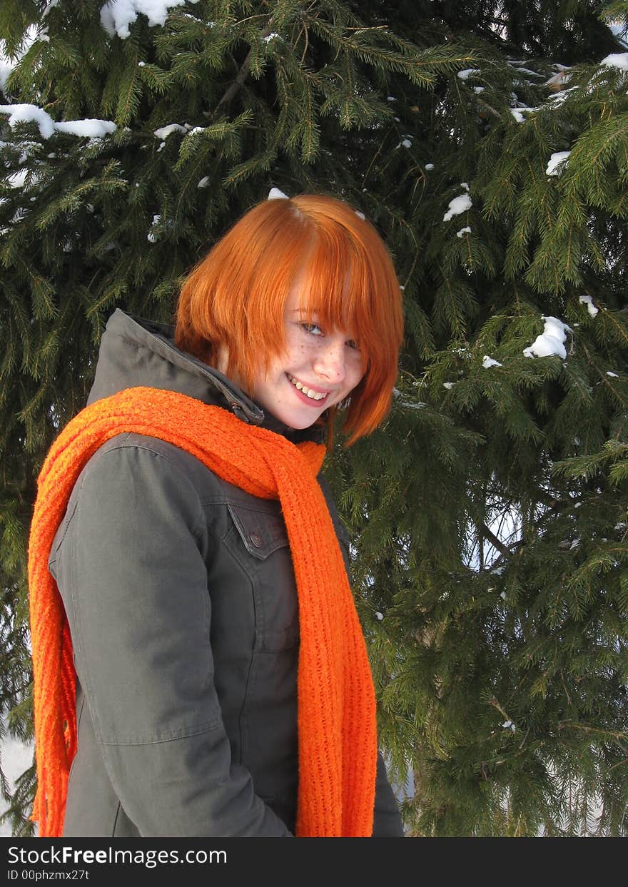 Red-haired girl with orange scarf and green fir