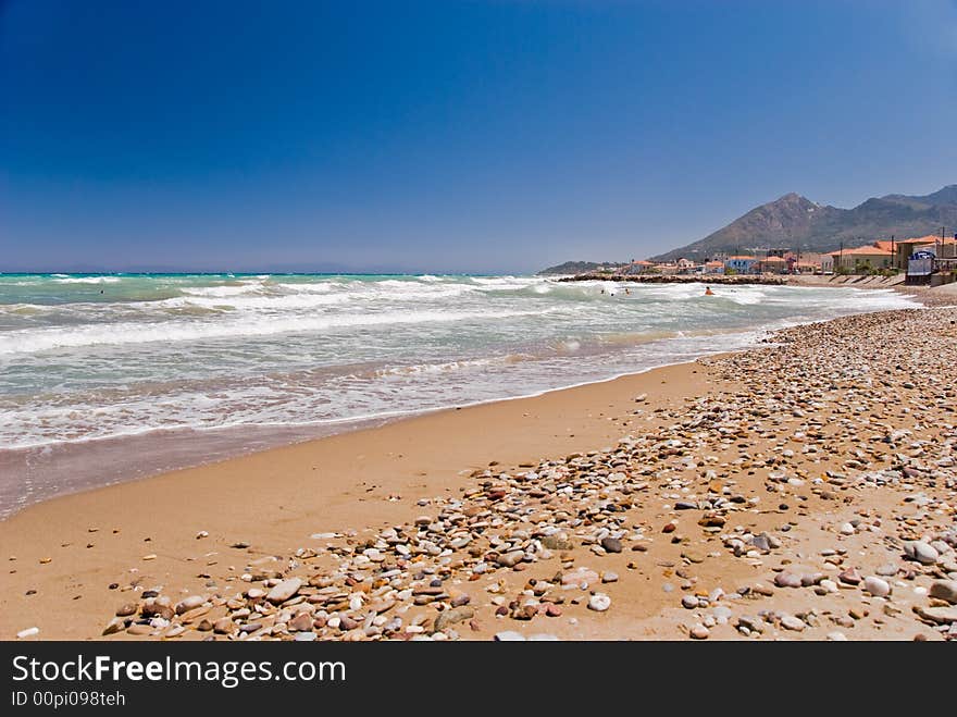 A small village on a beach. Samos island, Greece. People swimming in the see.