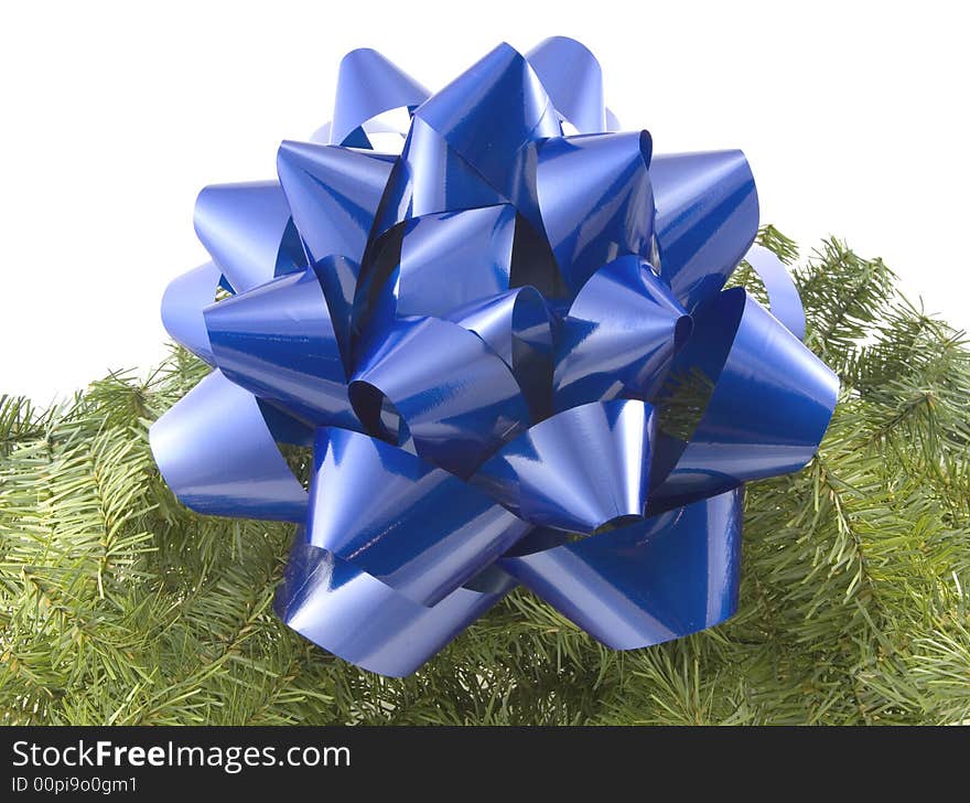 A blue bow and garland against a white background.