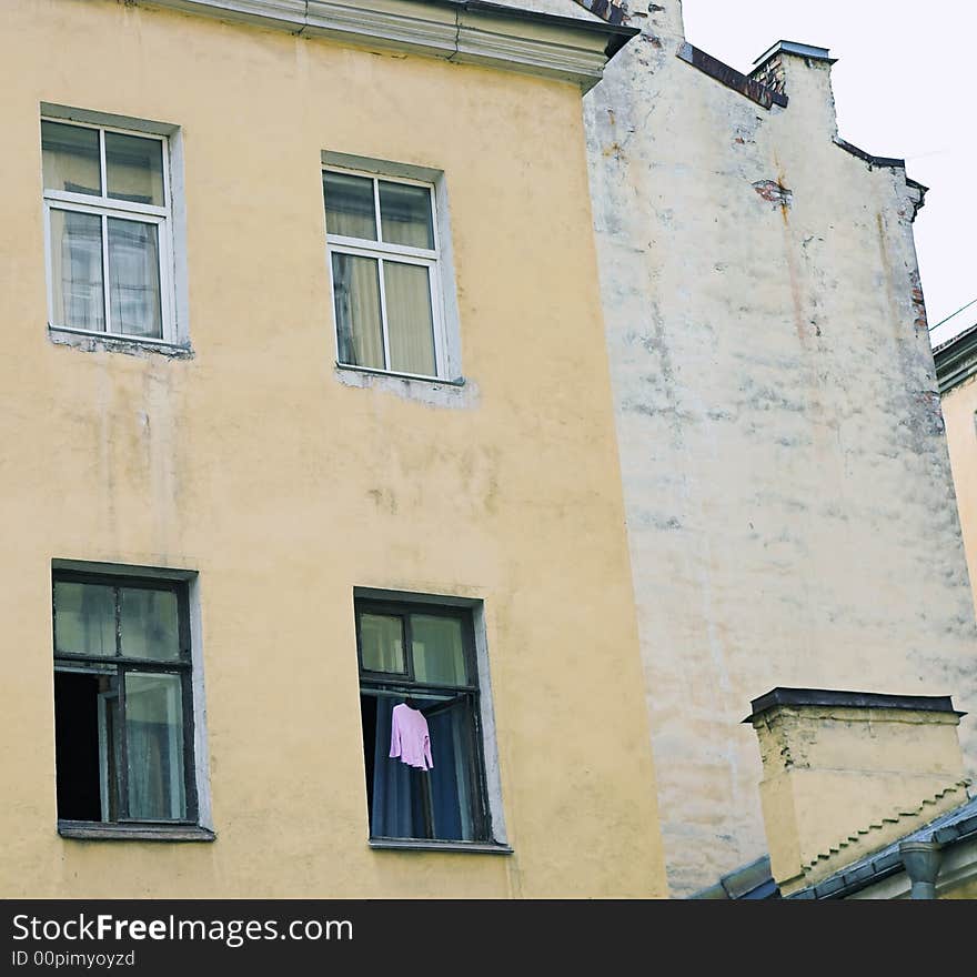 Dress hanging to dry in open window of old building. Dress hanging to dry in open window of old building